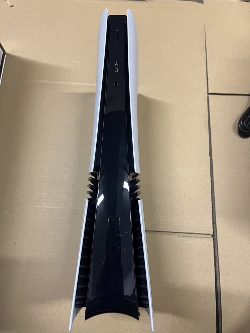 Front profile of a PlayStation 5 Pro console showing its power and USB ports