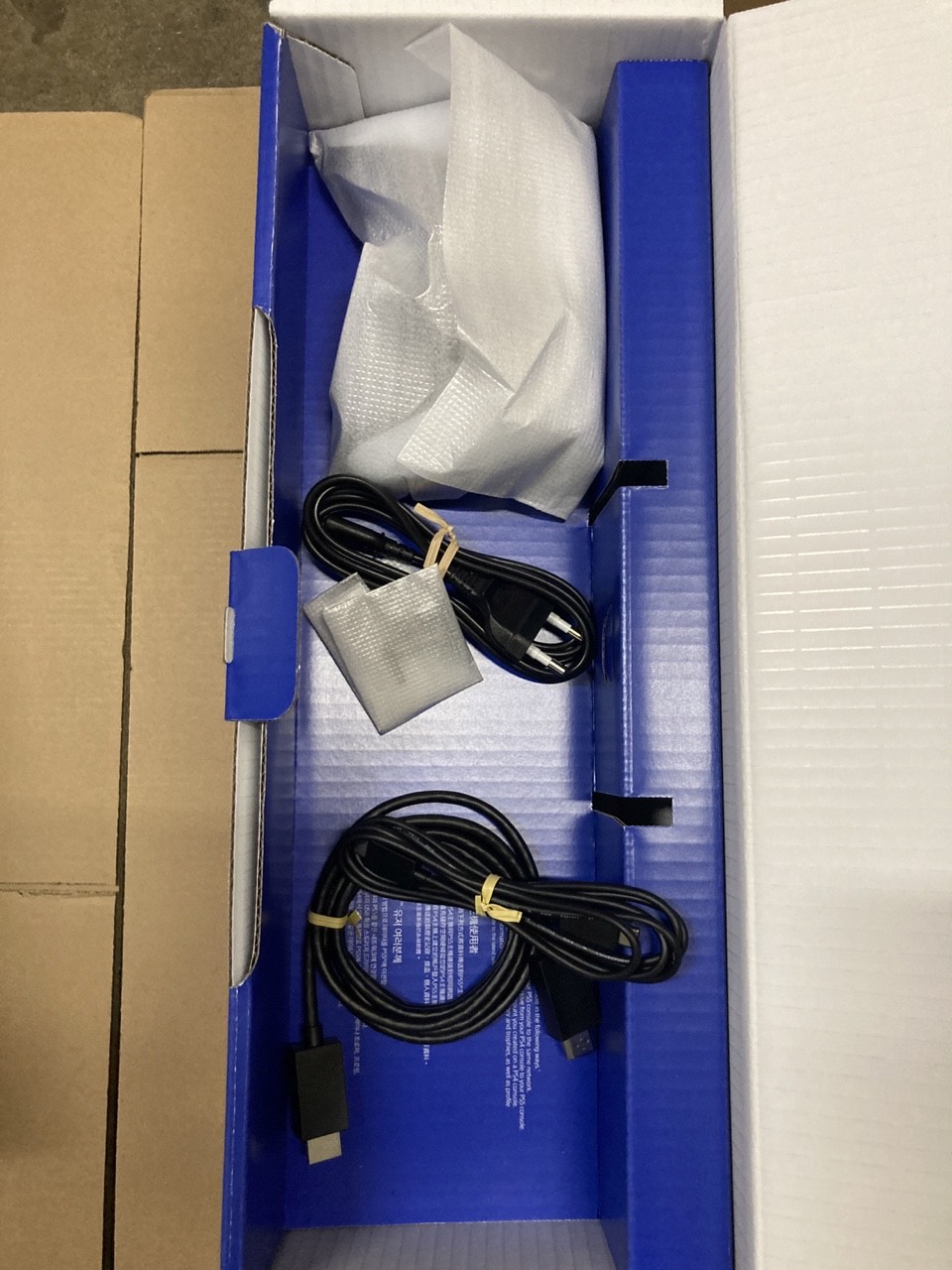 PlayStation 5 Pro box interior with supplied power, HDMI and USB cables
